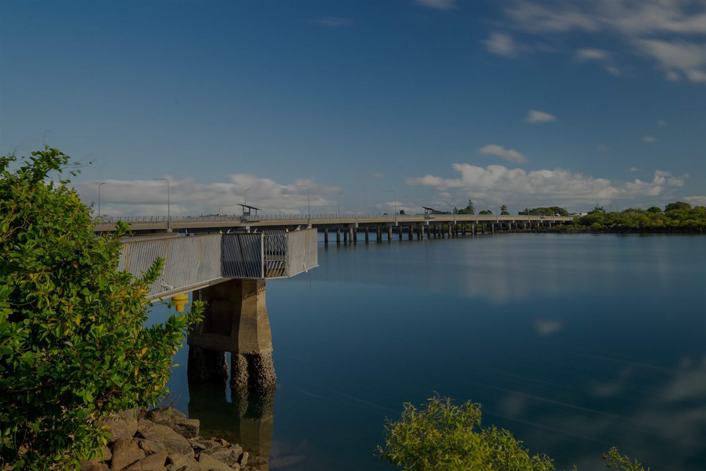 Sturdy bridge over tranquil waters, symbolising the reliability and structure maintained through prompt and efficient property maintenance services